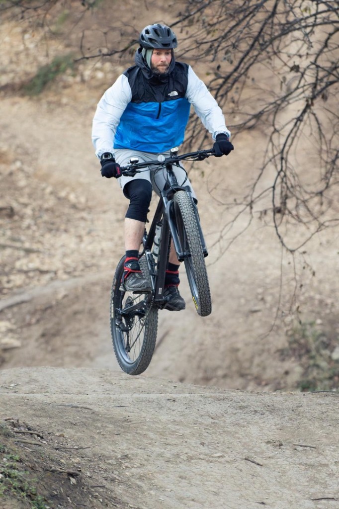 Mountain biker catching air on a dirt trail